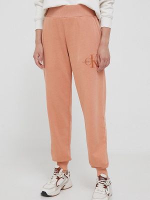 Spodnie sportowe bawełniane Calvin Klein Jeans pomarańczowe