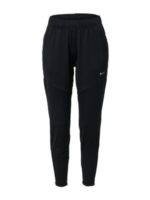 Obojstranné teplákové nohavice s potlačou s vreckami Nike - čierna
