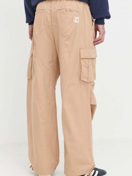 Jednobarevné bavlněné kalhoty Karl Kani béžové