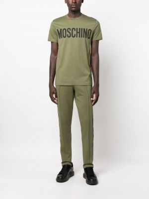 Bavlněné sportovní kalhoty s potiskem Moschino zelené