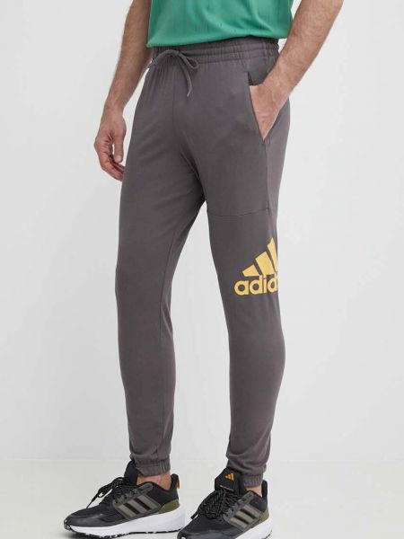Szare spodnie sportowe z nadrukiem Adidas