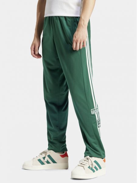 Priliehavé teplákové nohavice Adidas zelená