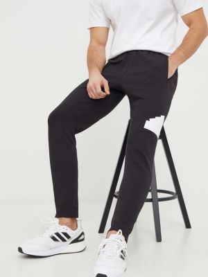 Czarne spodnie sportowe z nadrukiem Adidas