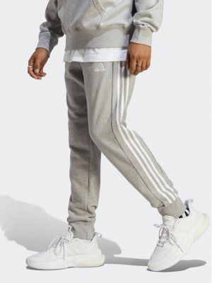 Pruhované priliehavé teplákové nohavice Adidas sivá