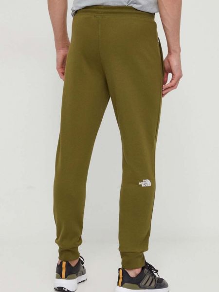 Bavlněné sportovní kalhoty The North Face zelené