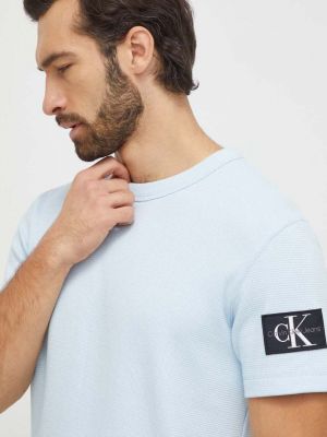 Памучна тениска с дълъг ръкав с апликация Calvin Klein Jeans синьо
