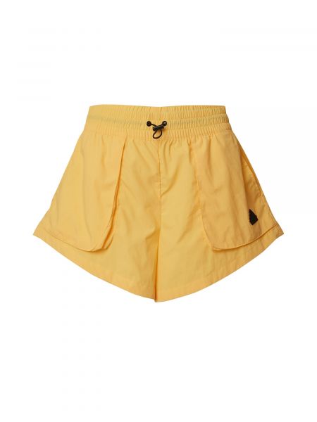 Voľné priliehavé teplákové nohavice Adidas Sportswear žltá