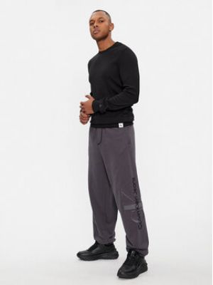 Sportovní kalhoty relaxed fit Calvin Klein Jeans šedé