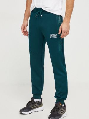 Sportovní kalhoty s aplikacemi Guess zelené