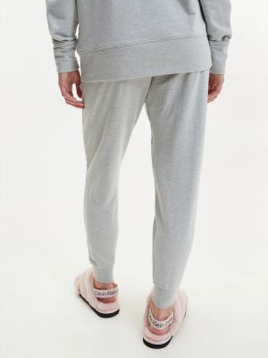 Teplákové nohavice Calvin Klein sivá