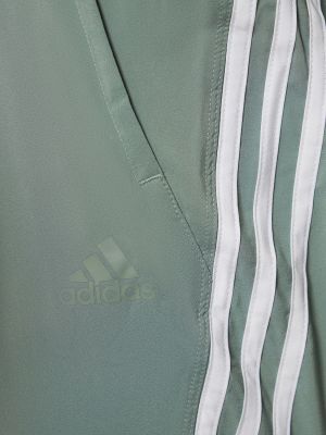 Pruhované teplákové nohavice Adidas Performance zelená