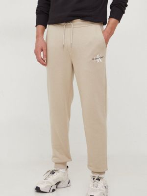 Spodnie sportowe z nadrukiem Calvin Klein Jeans beżowe
