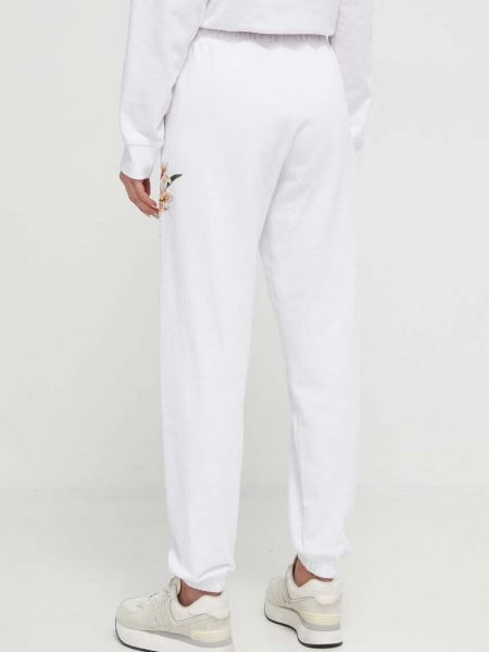 Bavlněné sportovní kalhoty s aplikacemi Guess bílé