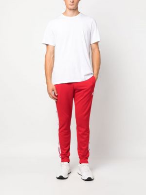 Haftowane spodnie sportowe Adidas czerwone