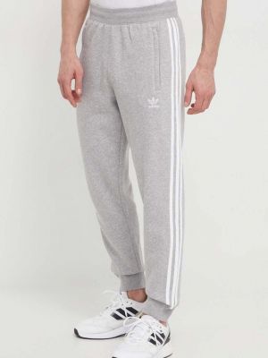 Melanžové pruhované sportovní kalhoty Adidas Originals šedé