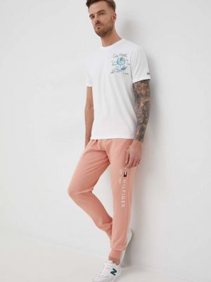 Бавовняні спортивні штани з аплікацією Tommy Hilfiger рожеві