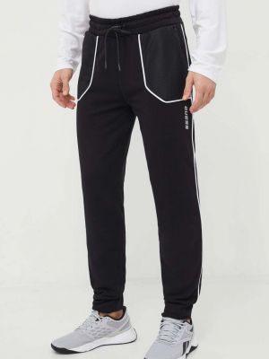 Sportovní kalhoty s aplikacemi Guess černé