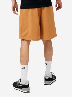 Pantaloni din bumbac New Balance portocaliu