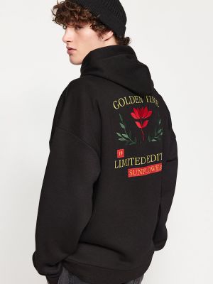Kapučdžemperis ar izšuvumiem ar ziediem ar apdruku Trendyol melns