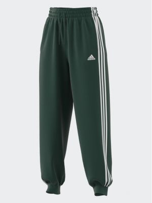 Pruhované sportovní kalhoty relaxed fit Adidas zelené