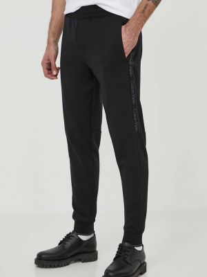 Černé sportovní kalhoty s aplikacemi Calvin Klein