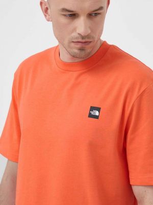 Памучна тениска с дълъг ръкав с принт The North Face оранжево