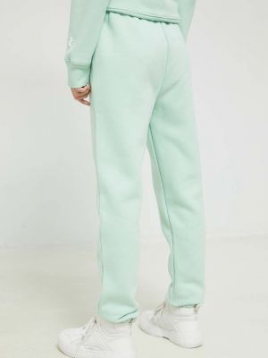 Sportovní kalhoty s aplikacemi Juicy Couture zelené