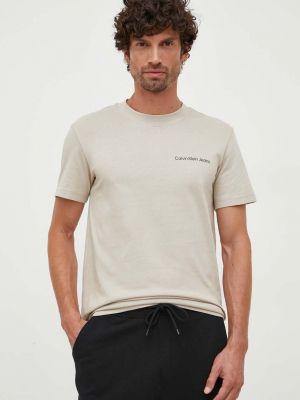 Памучна тениска с дълъг ръкав с апликация Calvin Klein Jeans бежово