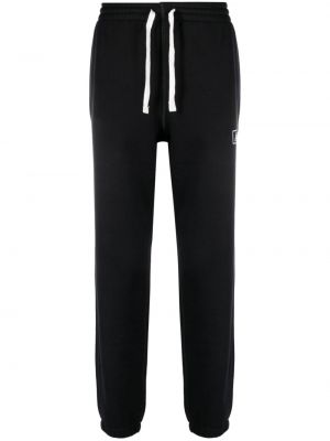 Bavlnené teplákové nohavice s potlačou New Balance čierna