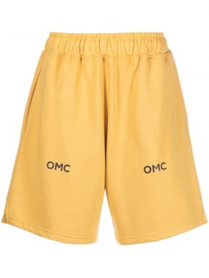 Kratke hlače s potiskom Omc rumena