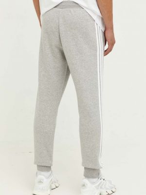 Sportovní kalhoty s aplikacemi Adidas Originals šedé