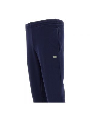 Spodnie sportowe bawełniane Lacoste niebieskie