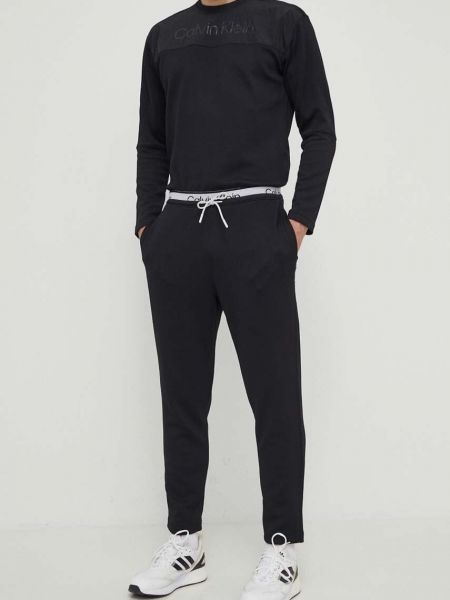 Czarne spodnie sportowe z nadrukiem Calvin Klein Performance