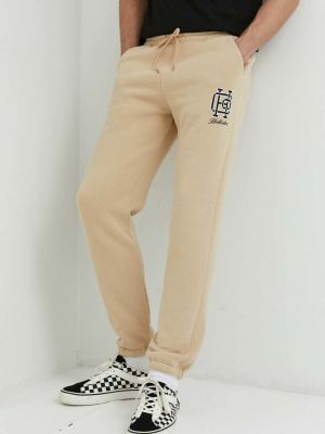 Sportovní kalhoty s potiskem Hollister Co. béžové