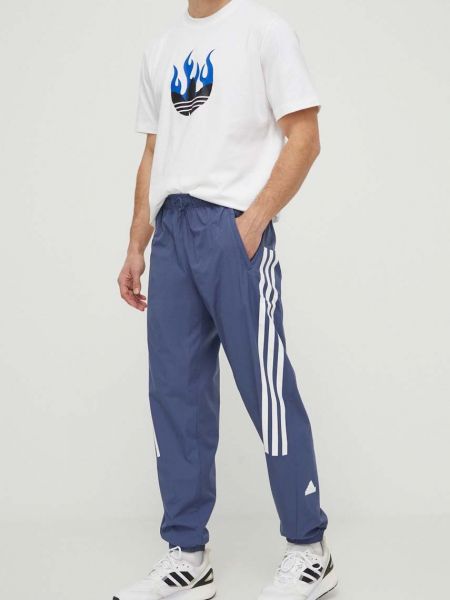 Niebieskie spodnie sportowe z nadrukiem Adidas