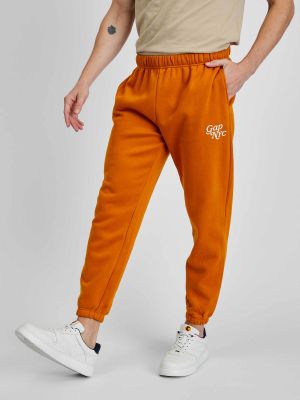 Teplákové nohavice Gap oranžová