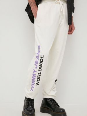 Spodnie sportowe bawełniane z nadrukiem Tommy Jeans beżowe