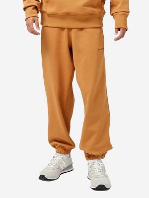 Pantaloni sport din bumbac New Balance portocaliu