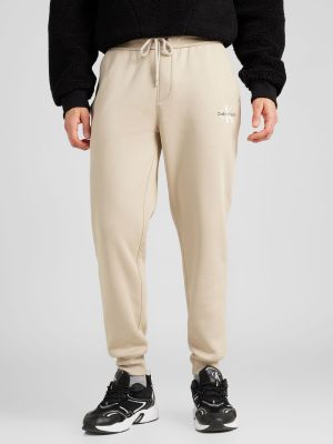 Sportinės kelnes Calvin Klein Jeans smėlinė