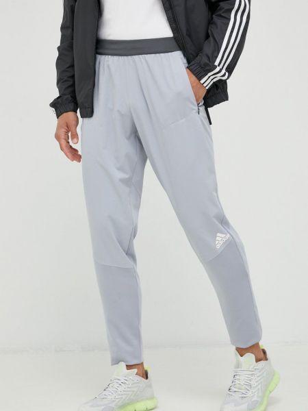 Kalhoty s potiskem Adidas Performance šedé