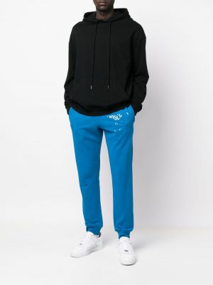 Sportovní kalhoty s potiskem Moschino modré