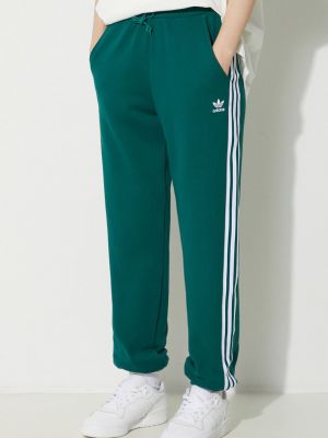 Bavlněné sportovní kalhoty s aplikacemi Adidas Originals zelené