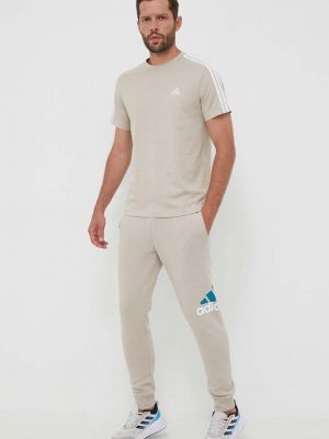 Spodnie sportowe z nadrukiem Adidas beżowe