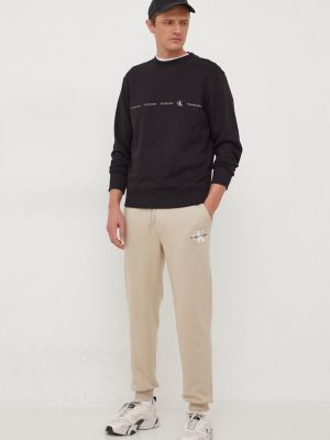 Spodnie sportowe z nadrukiem Calvin Klein Jeans beżowe