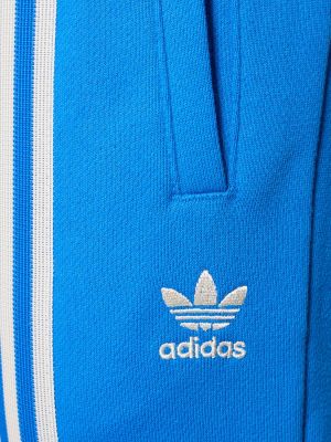 Pruhované sportovní kalhoty Adidas Originals modré