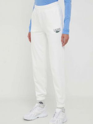 Бежеві спортивні штани з принтом Lacoste
