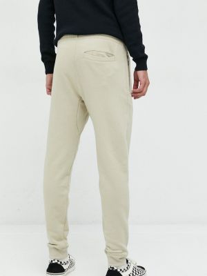 Bavlněné sportovní kalhoty s aplikacemi Superdry béžové
