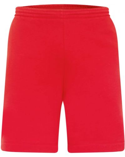 Teplákové nohavice Lacoste červená