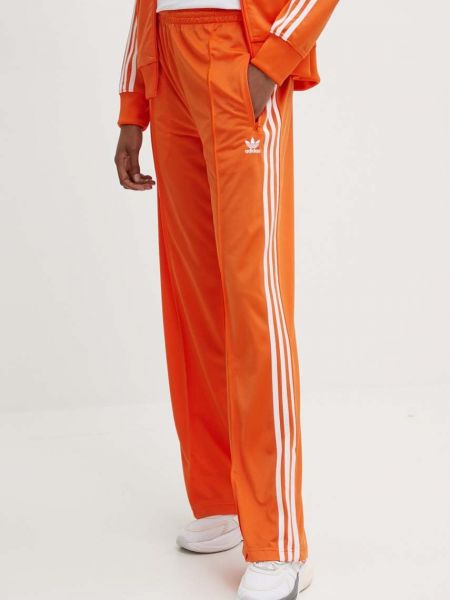 Spodnie sportowe relaxed fit Adidas pomarańczowe