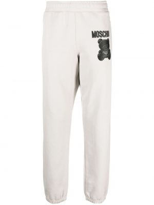 Bavlnené nohavice s potlačou Moschino sivá